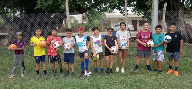 Children's soccer team with donated uniforms and cleats